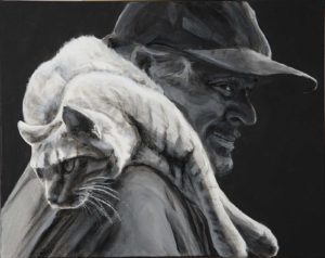 Dual portrait of a man with a cat laying across his shoulders. He smiles, her legs dangle in front as she looks backwards. With a black background and the mans face in shadow, the pale cat stands out.